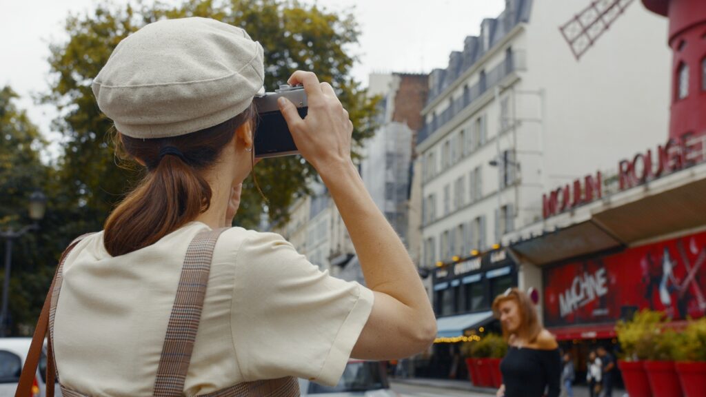 Young girl taking a photo in Montmartre